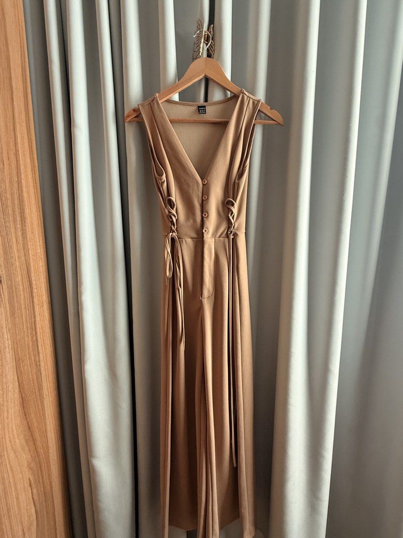 Khaki Jumpsuit Vest with Tie (Category: Jumpsuits) located in Makati City. Submitted by regalbbb (Listing ID 1470214996, Image 1). Description: Original Price: Around 750 RFS: Decluttering Condition: Used a few times but no flaws. Shein sizes run big so xs is really more small. - Brand/Style: SHEIN MOD Camel Wide-Leg Jumpsuit - Design: Elegant V-neckline with functional front buttons and sleeveless cut - Details: Trendy lace-up ties on both sides