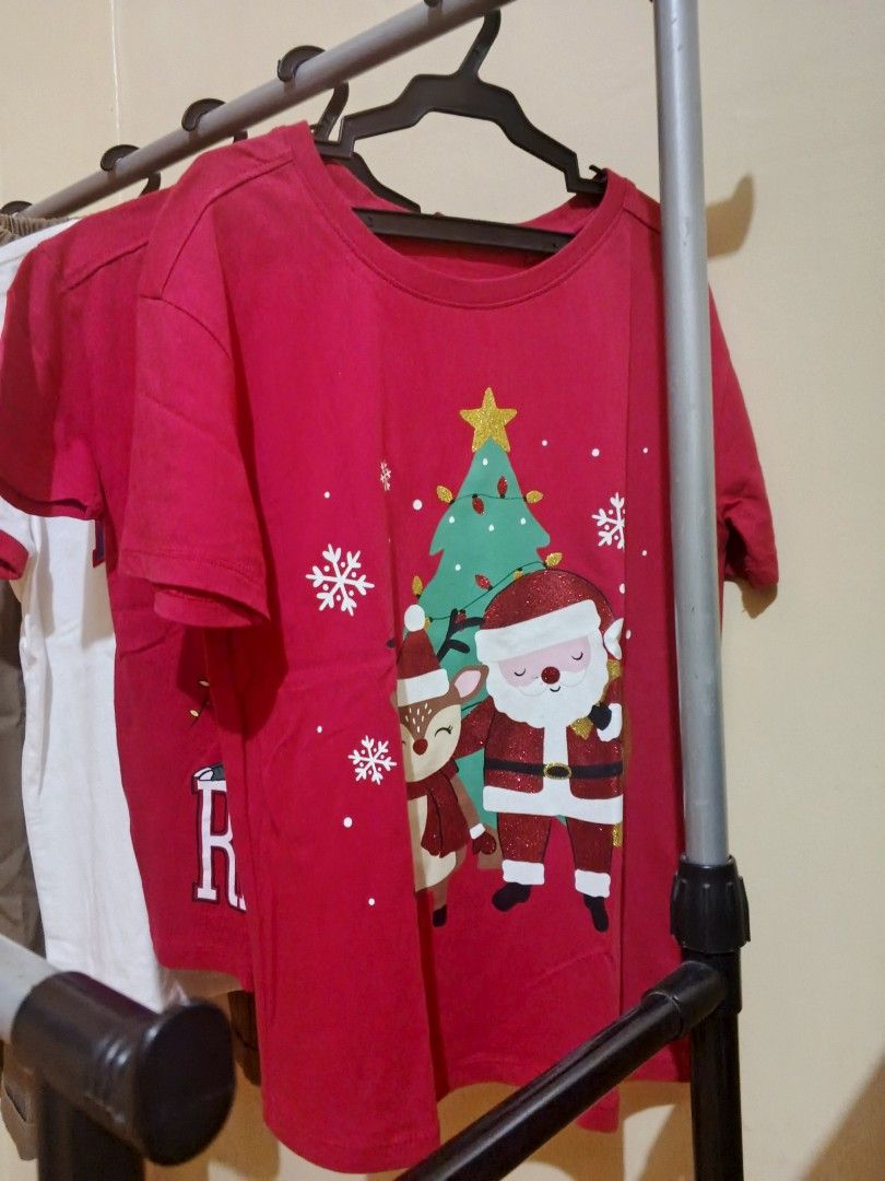 Kids Bundle Mossimo Shirt Christmas Tees Pants (Category: Babies & Kids Fashion) located in Lapu Lapu. Submitted by dawatkrist14304 (Listing ID 1470297020, Image 3). Description: - 5-piece kids' clothing bundle - 1x White Mossimo New York ringer tee - 2x Red holiday shirts with festive Christmas graphics - 2× Brown trousers with a comfortable elastic waistband - Condition: Clean fabrics, neatly stored on hangers - Perfect mix for everyday casual 