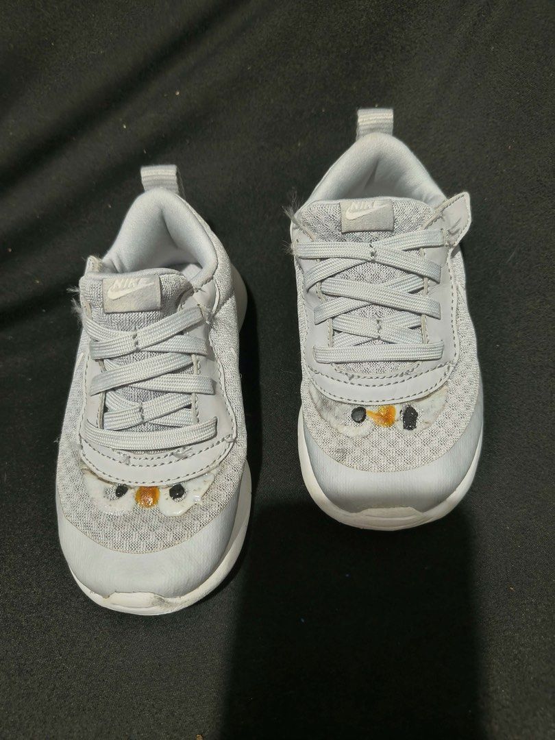 Kids Nike Grey Sneakers (Category: Babies & Kids Fashion) located in Manila. Submitted by kiyanna.preloved (Listing ID 1470252203, Image 2). Description: - Brand: Nike kids sneakers - Color: Grey with white rubber soles - Fastening: Elastic laces and convenient velcro strap - Design: Cute embroidered bird/chick detail on the toe - Features: Fabric pull tab at the back for easy wearing - Size: 15cm - Condition: Light wear underneath soles; previou