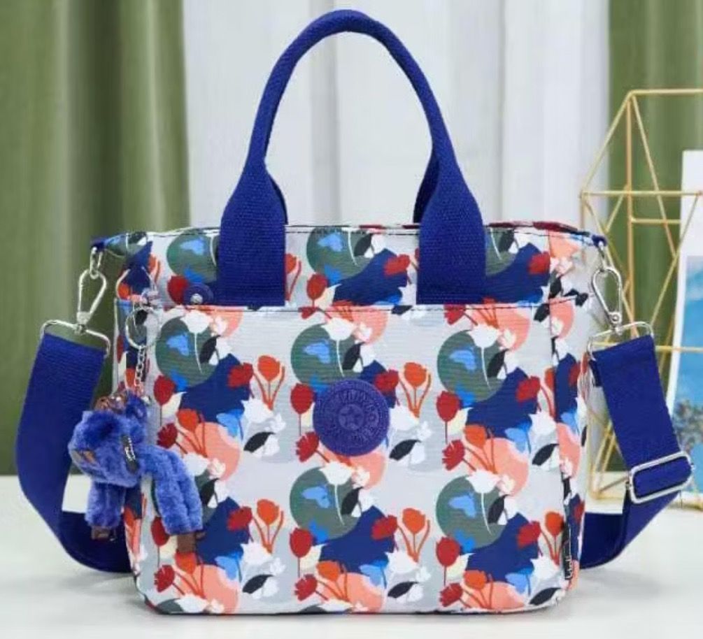 Kipling Floral Print Tote Bag Shoulder Bag (Category: Shoulder Bags) located in Bulacan. Submitted by tytoluxe (Listing ID 1470247469, Image 3). Description: Minimum purchase of 2 off per order - Brand: Kipling floral print tote bag - Design: Multi-color pattern featuring reds, greens, and greys on a light background - Features: Secure zipper top closure, convenient exterior front pocket, and durable dual black top handles - Includes: Iconic matc