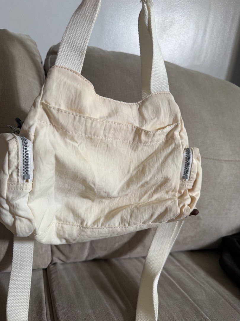 Kipling White Nylon Shoulder Bag with Crossbody Strap (Category: Shoulder Bags) located in Makati City. Submitted by triftedandbranded (Listing ID 1470230543, Image 1). Description: - Authentic white Kipling shoulder bag made from durable, lightweight nylon - Versatile design featuring both top handles and an adjustable/removable crossbody strap - Excellent storage with a front flap pocket, side zip pockets, and a spacious main compartment - Incl