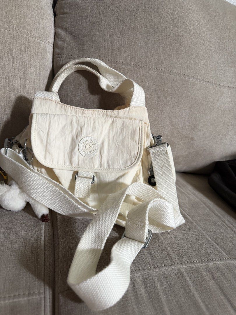 Kipling White Nylon Shoulder Bag with Crossbody Strap (Category: Shoulder Bags) located in Makati City. Submitted by triftedandbranded (Listing ID 1470230543, Image 3). Description: - Authentic white Kipling shoulder bag made from durable, lightweight nylon - Versatile design featuring both top handles and an adjustable/removable crossbody strap - Excellent storage with a front flap pocket, side zip pockets, and a spacious main compartment - Incl