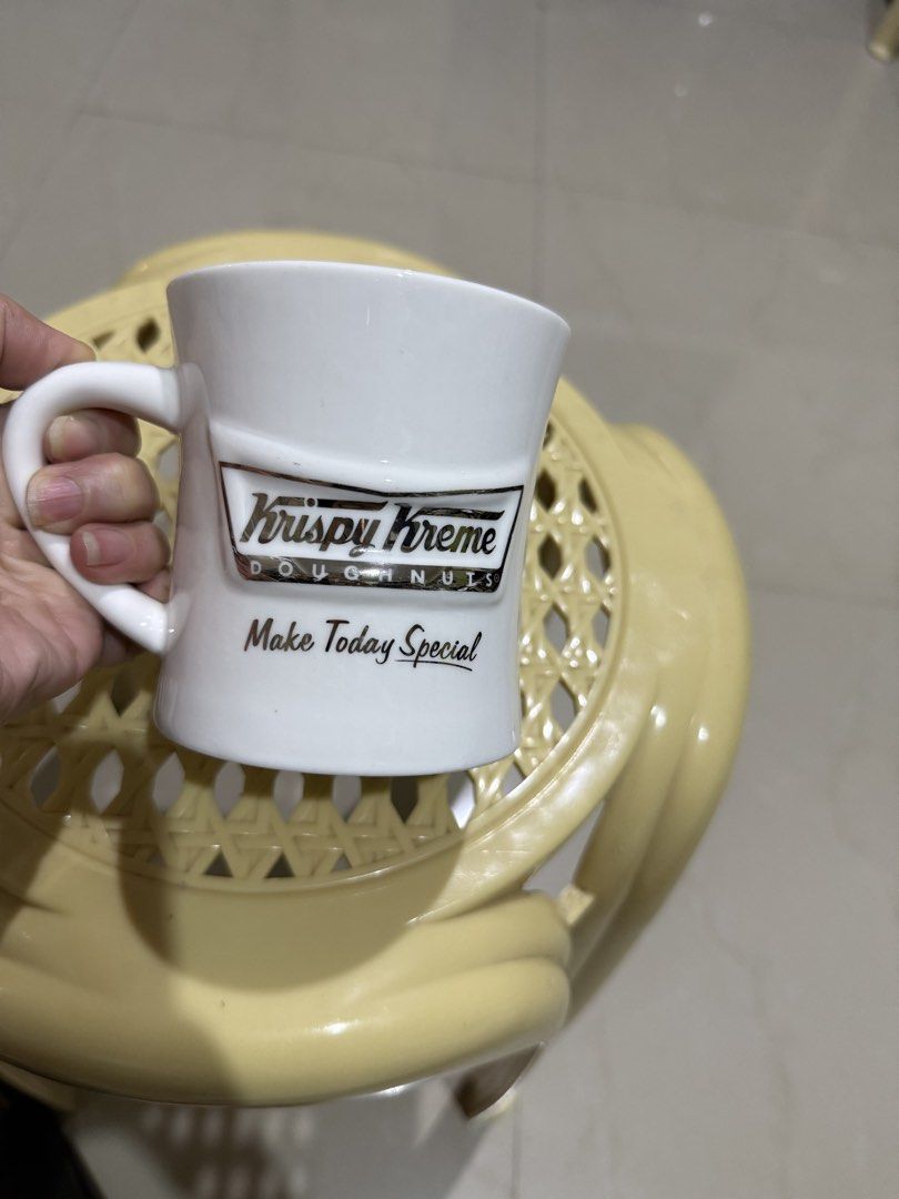 Krispy Kreme Doughnuts White Ceramic Coffee Mug (Category: Coffee & Tea Tableware) located in Mandaue City. Submitted by erin_grace (Listing ID 1470166840, Image 3). Description: - Brand: Krispy Kreme Doughnuts - Material: Clean white ceramic - Design: Raised silver-tone logo with 'Make Today Special' text - Features: Comfortable curved side handle - Capacity: Standard mug size for coffee, tea, and hot beverages.