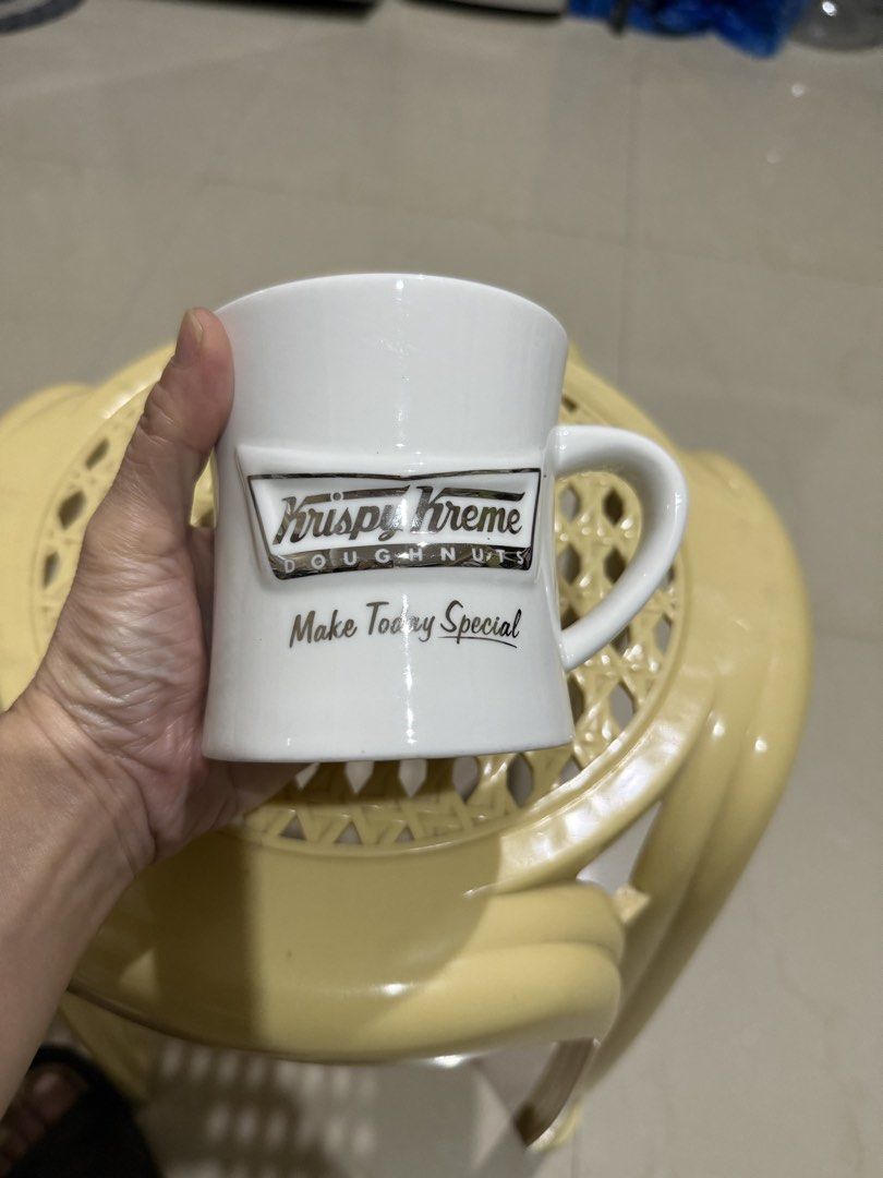 Krispy Kreme Doughnuts White Ceramic Coffee Mug (Category: Coffee & Tea Tableware) located in Mandaue City. Submitted by erin_grace (Listing ID 1470166840, Image 1). Description: - Brand: Krispy Kreme Doughnuts - Material: Clean white ceramic - Design: Raised silver-tone logo with 'Make Today Special' text - Features: Comfortable curved side handle - Capacity: Standard mug size for coffee, tea, and hot beverages.