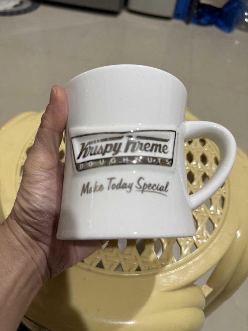 Krispy Kreme Doughnuts White Ceramic Coffee Mug (Category: Coffee & Tea Tableware) located in Mandaue City. Submitted by erin_grace (Listing ID 1470166840, Image 2). Description: - Brand: Krispy Kreme Doughnuts - Material: Clean white ceramic - Design: Raised silver-tone logo with 'Make Today Special' text - Features: Comfortable curved side handle - Capacity: Standard mug size for coffee, tea, and hot beverages.
