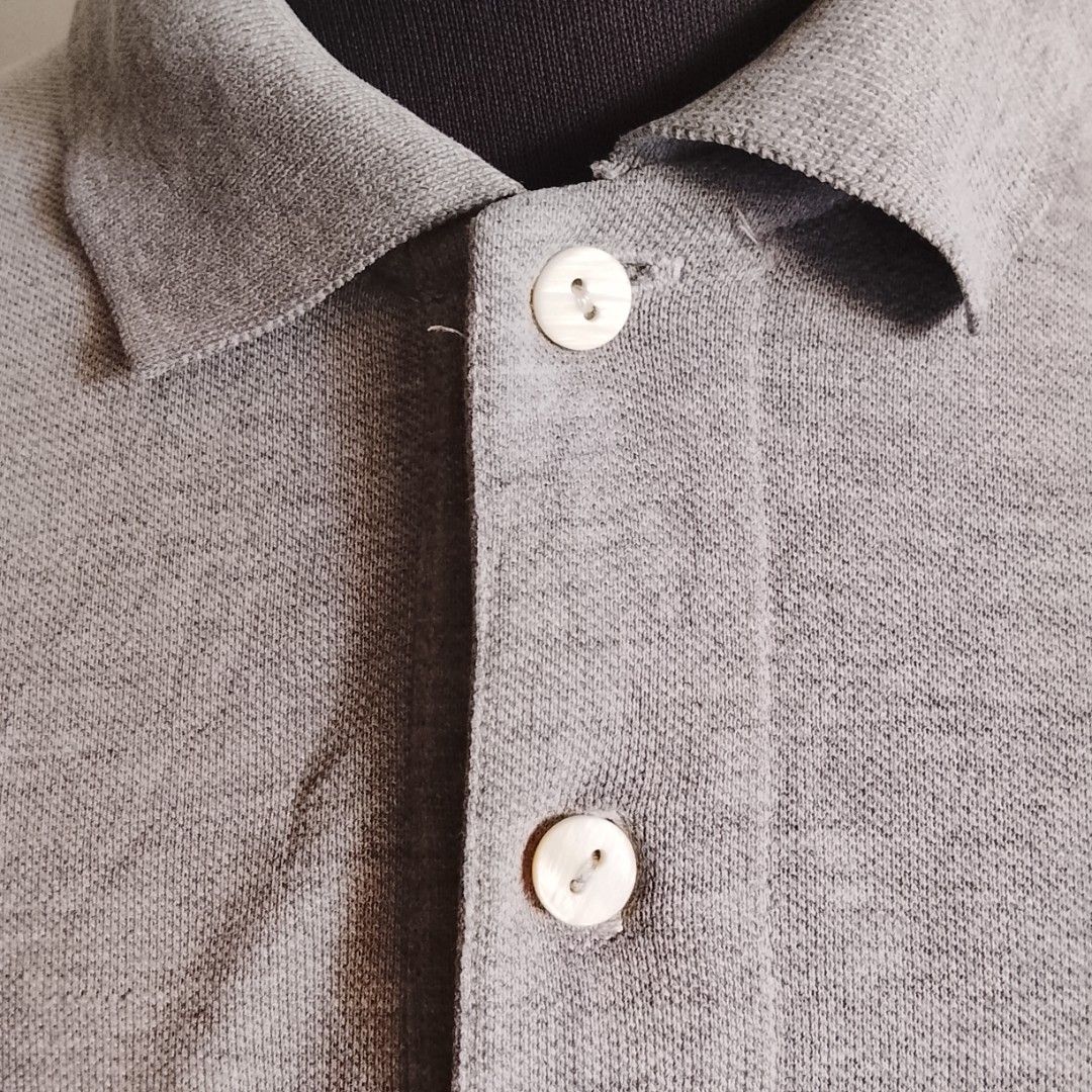 Lacoste - Gray Polo Shirt (Category: Luxury Apparel) located in Angeles City. Submitted by sselects_ (Listing ID 1470157272, Image 3). Description: Details of the item: *Color may vary due to lighting Size: 6 on tag, fits L-XL imo Width: 21" Length: 28" Issue: small yellow stain on button part, removable Condition: Good ALL ITEMS ARE NEGOTIABLE.