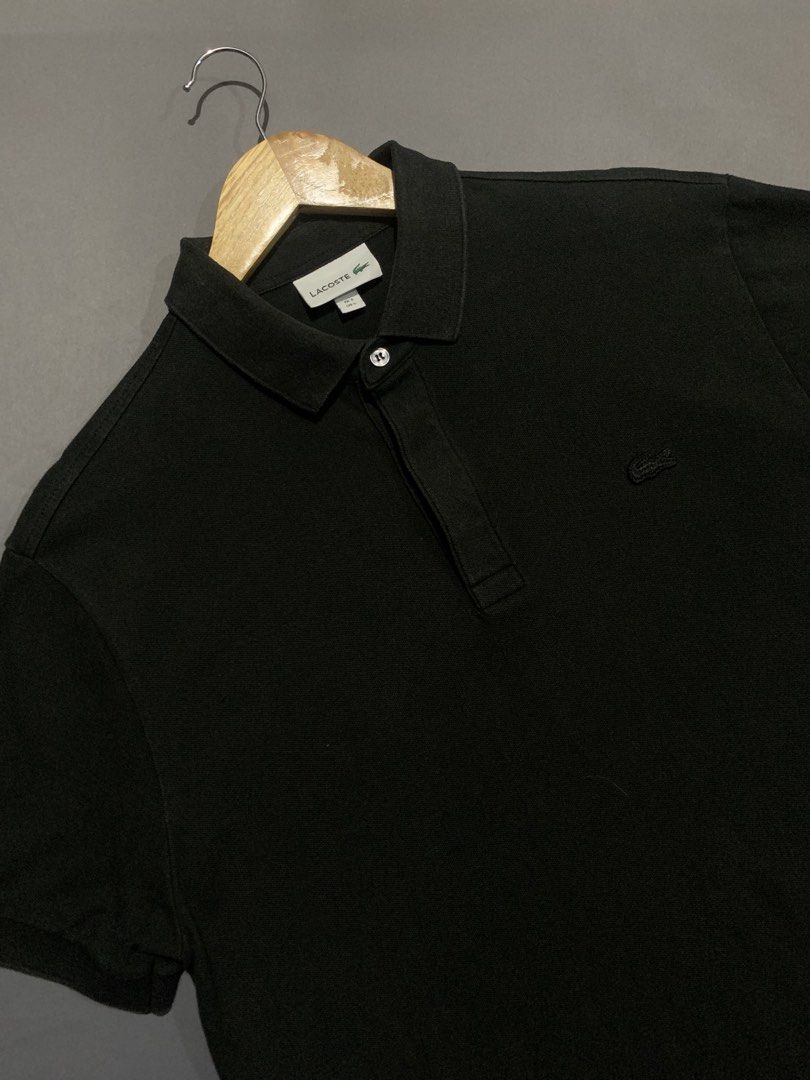Lacoste Black Polo Shirt (Category: Tshirts & Polo Shirts ) located in Bacacay. Submitted by ukayfindssss (Listing ID 1470144972, Image 2). Description: - Brand: Lacoste - Color: Classic Black - Size: Fits like a Large (22" width x 28" length) - Details: Classic collar with single button placket & embroidered crocodile logo on chest - Condition: Clean fabric, zero flaws, ready to wear.