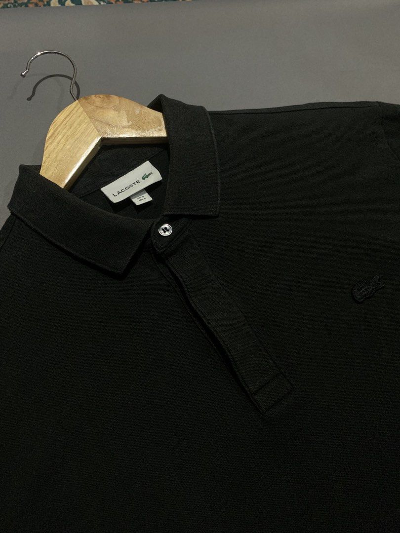 Lacoste Black Polo Shirt (Category: Tshirts & Polo Shirts ) located in Bacacay. Submitted by ukayfindssss (Listing ID 1470144972, Image 3). Description: - Brand: Lacoste - Color: Classic Black - Size: Fits like a Large (22" width x 28" length) - Details: Classic collar with single button placket & embroidered crocodile logo on chest - Condition: Clean fabric, zero flaws, ready to wear.