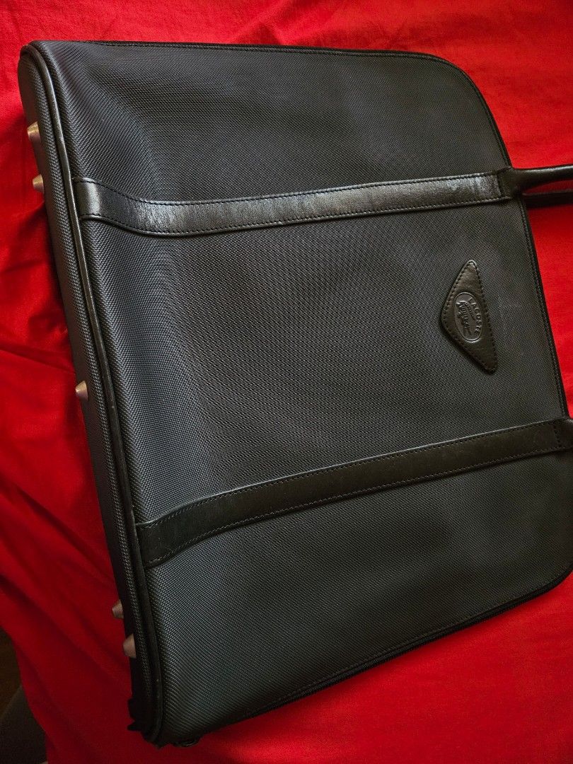 Lacoste Black Tote Bag Laptop Briefcase (Category: Tote Bags) located in Mandaluyong City. Submitted by ohwmaria (Listing ID 1470229675, Image 3). Description: -Laptop/Ipad/Tablet/Document bag - Color: Classic Black - Material: Textured nylon fabric with premium leather trim - Design: Structured rectangular shape with dual top handles - Logo: Distinctive triangular leather patch with embossed Lacoste crocodile - Closure: Secure top zip closure - 
