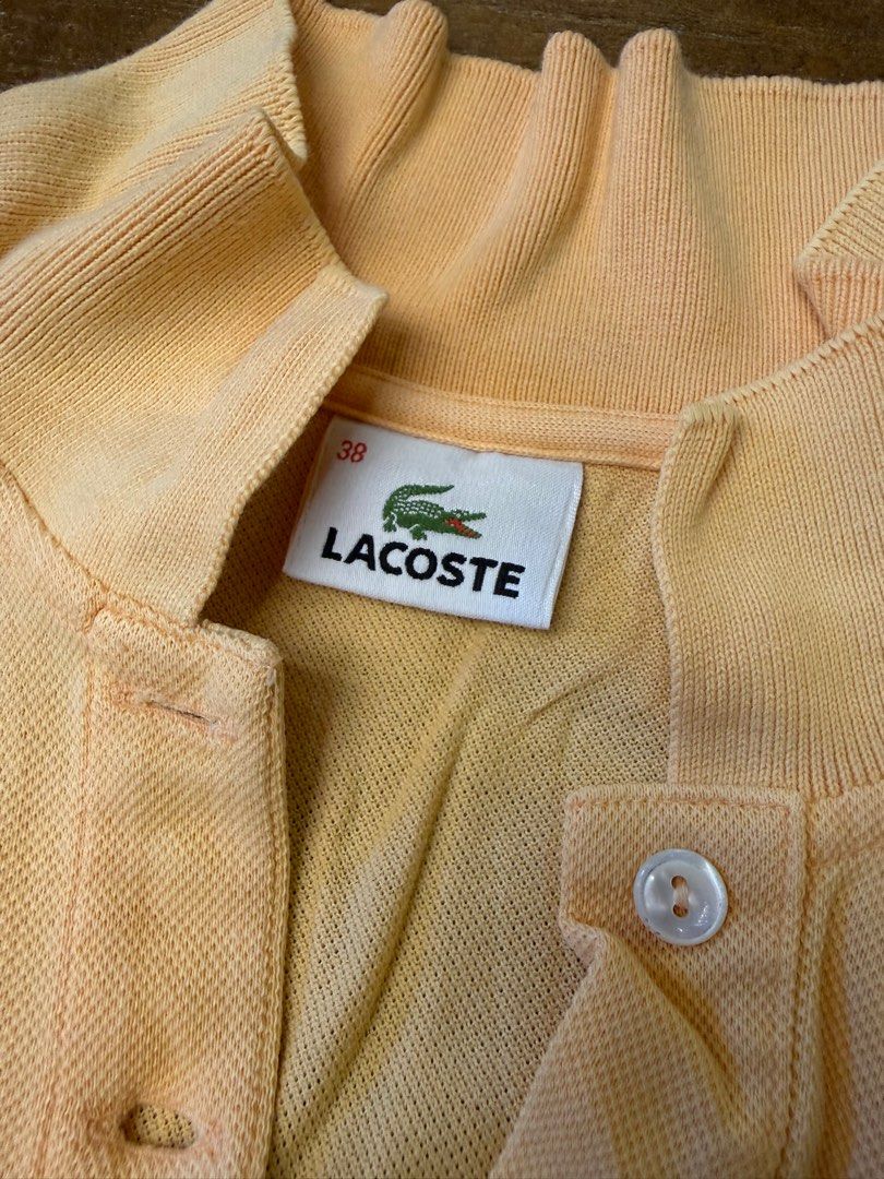 Lacoste Peach Polo Shirt Size 38 (Category: Shirts) located in Muntinlupa City. Submitted by el1b12345 (Listing ID 1470183768, Image 3). Description: - Brand: Lacoste - Color: Peach - Size: 38 (Standard fit) - L - 22" - W - 17" - Classic two-button placket with white buttons - Traditional ribbed collar and sleeve cuffs - Signature embroidered green crocodile logo on left chest - Clean inner brand tag - mop: Gcash - mod: Lalamove/J&T - Price Negot