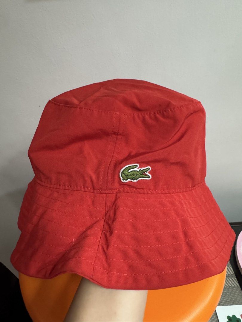 Lacoste Red Bucket Hat 👒 (Category: Babies & Kids Fashion) located in Valenzuela. Submitted by sofiasticated.decluttering (Listing ID 1470171702, Image 2). Description: - Brand: Lacoste - Style: Bucket Hat (Model RK6006) - Color: Bright Red - Size: Small - Logo: Iconic embroidered green crocodile on the side - Details: Interior branded LACOSTE red straps across the crown - Material: 100% lightweight polyester - Condition: Excellent 📌A lovely se