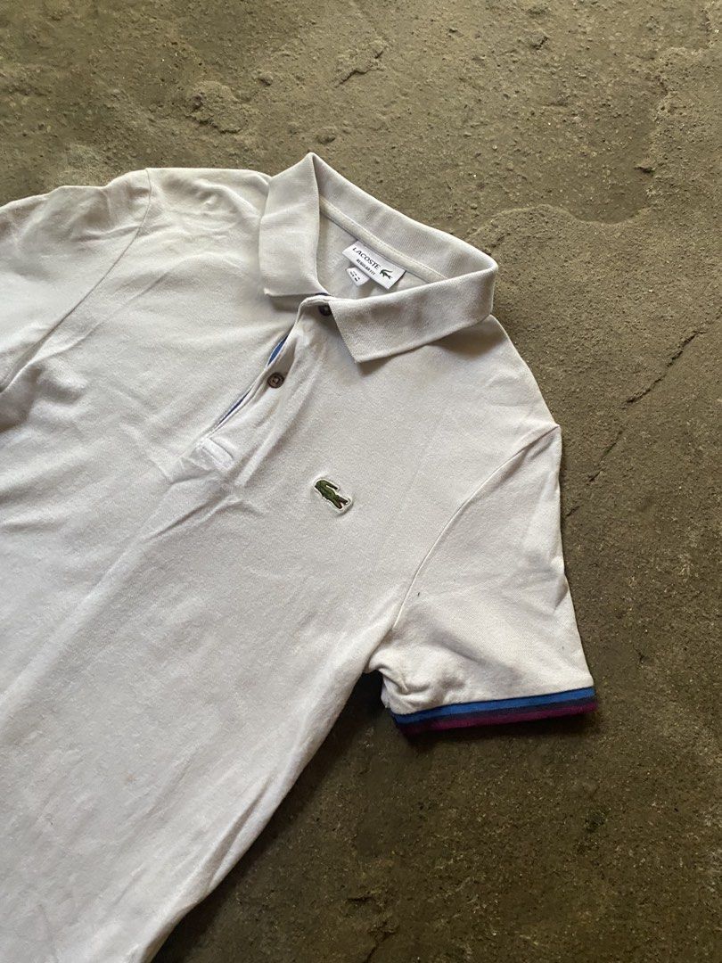 Lacoste Regular Fit Polo Shirt White Size M (Category: Tshirts & Polo Shirts ) located in Caloocan City. Submitted by remythrift (Listing ID 1470187492, Image 2). Description: White Lacoste polo shirt in regular fit. Size FR 4, US M. Classic green crocodile logo on the chest. Ribbed collar and striped sleeve cuffs in blue and burgundy tones. Two-button placket with dark buttons. Clean basic piece for casual wear. Grab it before it's gone..