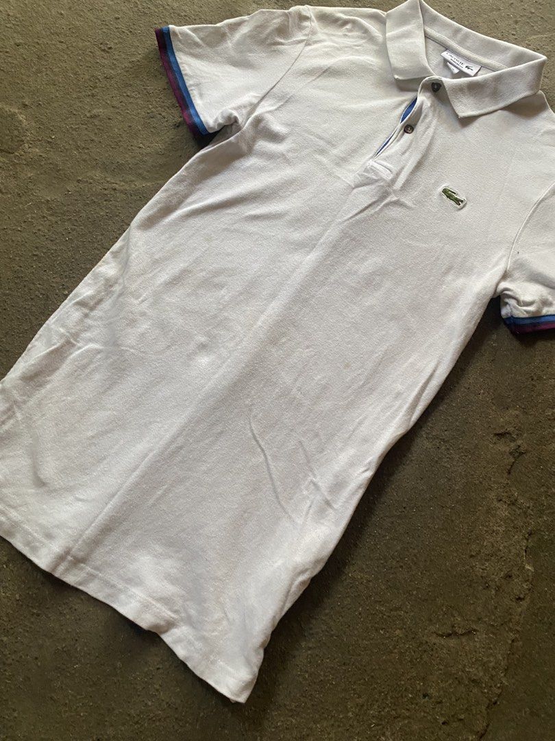 Lacoste Regular Fit Polo Shirt White Size M (Category: Tshirts & Polo Shirts ) located in Caloocan City. Submitted by remythrift (Listing ID 1470187492, Image 3). Description: White Lacoste polo shirt in regular fit. Size FR 4, US M. Classic green crocodile logo on the chest. Ribbed collar and striped sleeve cuffs in blue and burgundy tones. Two-button placket with dark buttons. Clean basic piece for casual wear. Grab it before it's gone..