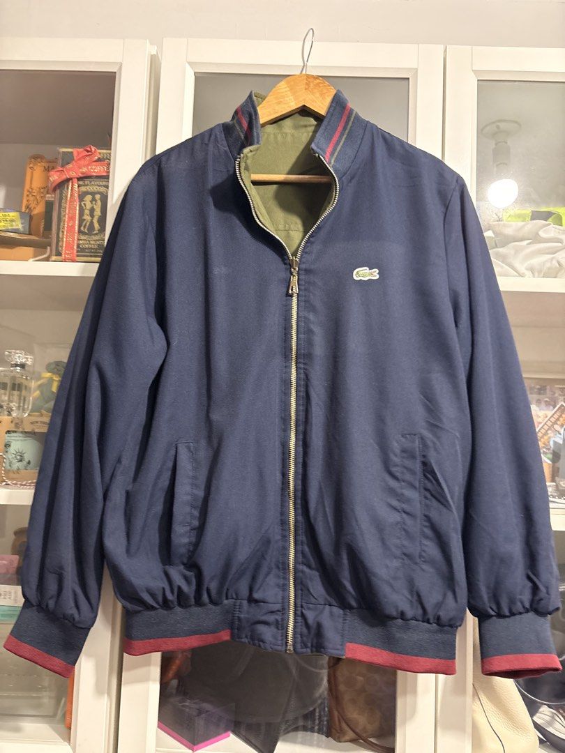 Lacoste Reversible Bomber Jacket Navy Olive Green (Category: Coats, Jackets and Outerwear) located in Quezon City. Submitted by garageband (Listing ID 1470268065, Image 2). Description: - Lacoste reversible bomber jacket - chest 22 inch, length 27 inch - Dual-color design: Navy blue on side A, olive green on side B - Classic embroidered crocodile logo on the chest - Stylish ribbed collar, cuffs, and hem with red and blue stripes - Functional side