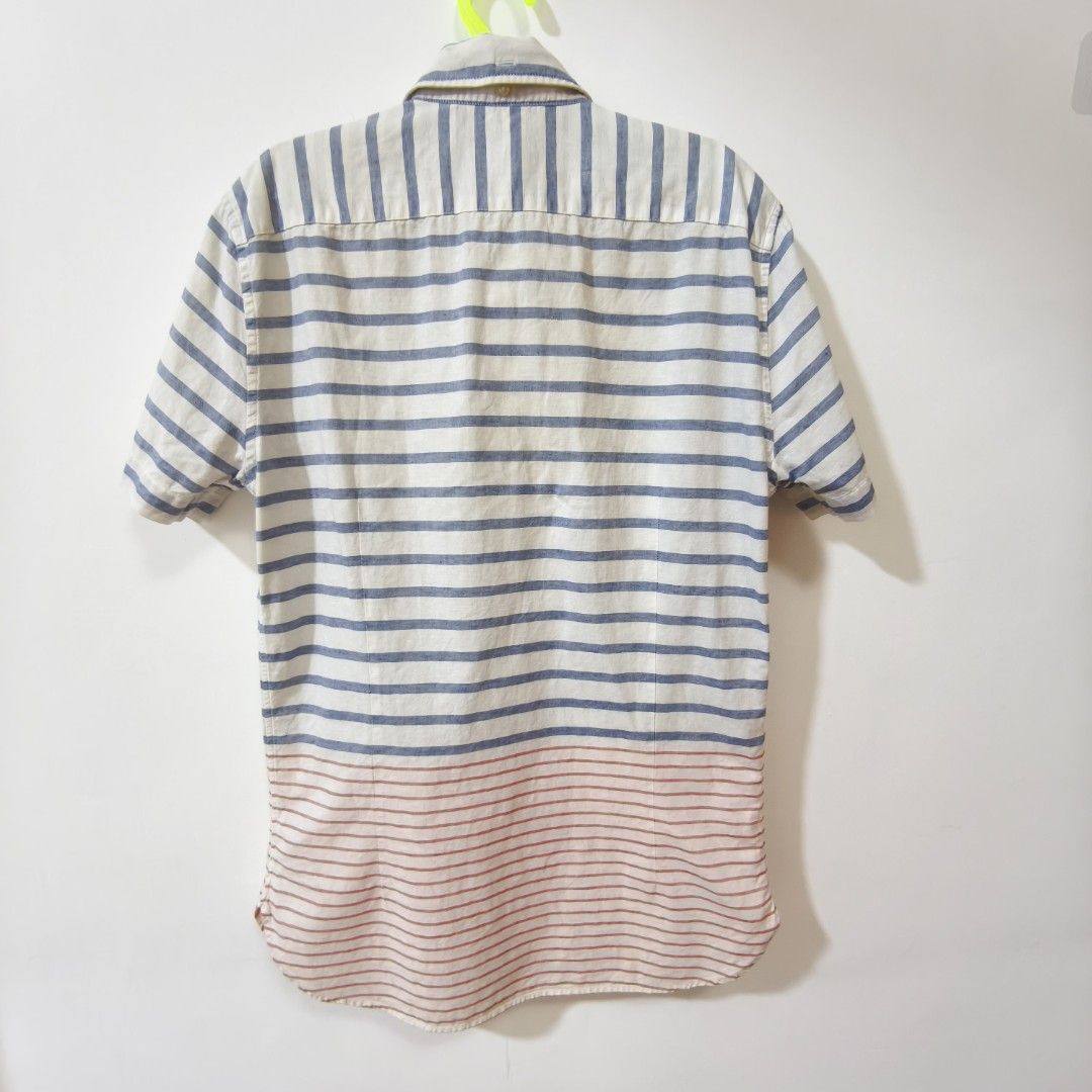 Lacoste Striped Short Sleeve Linen Blend Button-Down Shirt (Category: Tshirts & Polo Shirts ) located in Quezon City. Submitted by inrelationthrift (Listing ID 1470194020, Image 2). Description: - Brand: Lacoste - Style: Short-sleeve button-down shirt with chest pocket - Design: White base with blue horizontal stripes on the upper body and red stripes near the hem - Logo: Iconic embroidered green crocodile on the chest - Material: 80% Cotton, 20%