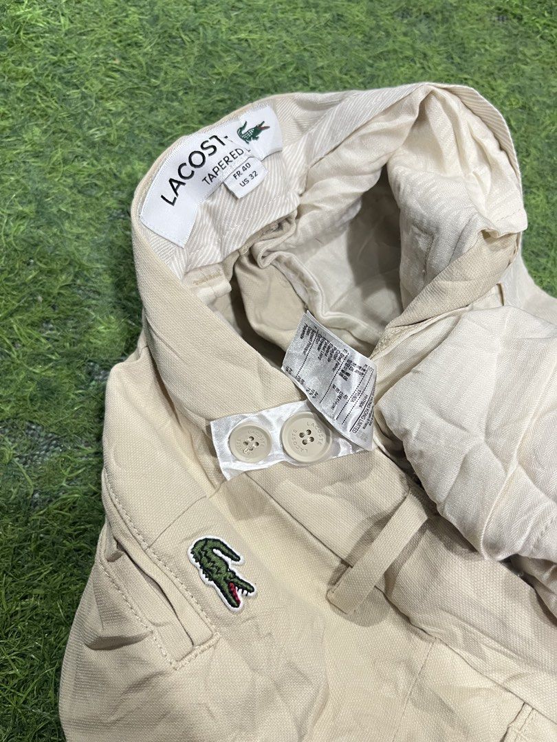 Lacoste Tapered Pants Beige US 32 (Category: Trousers) located in Balamban. Submitted by gogochrist09668 (Listing ID 1470279660, Image 3). Description: - Brand: Lacoste - Style: Tapered chino pants, style number HH7604 - Color: Classic beige - Size: French 40 / US 32 32W 36.5L - Condition: Brand new with tags attached - Details: Button closure, belt loops, and iconic embroidered crocodile logo near the pocket - Perfect for: Office wear, smart cas