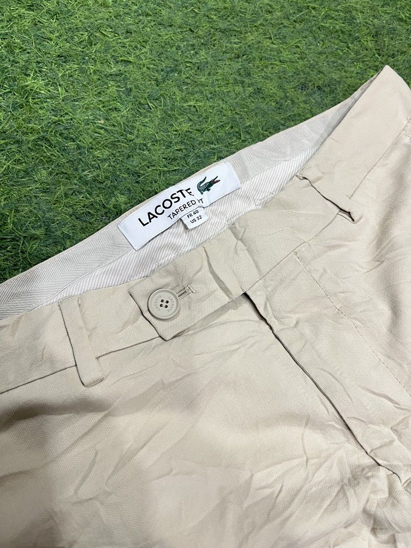 Lacoste Tapered Pants Beige US 32 (Category: Trousers) located in Balamban. Submitted by gogochrist09668 (Listing ID 1470279660, Image 2). Description: - Brand: Lacoste - Style: Tapered chino pants, style number HH7604 - Color: Classic beige - Size: French 40 / US 32 32W 36.5L - Condition: Brand new with tags attached - Details: Button closure, belt loops, and iconic embroidered crocodile logo near the pocket - Perfect for: Office wear, smart cas