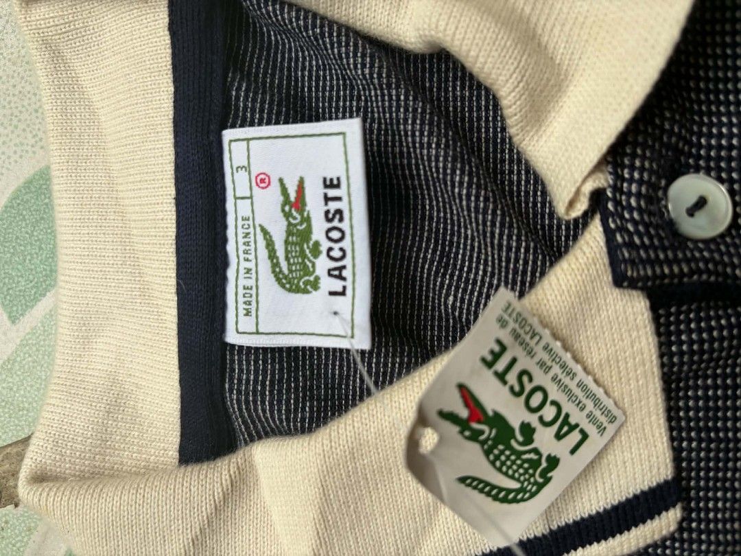 Lacoste Textured Navy Polo Shirt Size 3 (Category: Tshirts & Polo Shirts ) located in Victorias. Submitted by warmstorm-8b47 (Listing ID 1470202075, Image 3). Description: - Brand: Lacoste - Color: Dark navy blue with contrast off-white collar and sleeve cuffs - Size: 3 (Made in France) - Material & Design: Textured weave pattern with dark blue tipping lines on collar and cuffs - Details: Three-button placket with pearlescent buttons and classic 