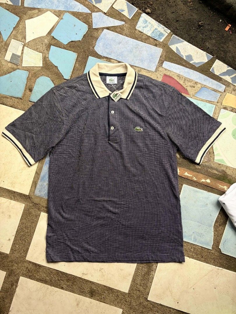 Lacoste Textured Navy Polo Shirt Size 3 (Category: Tshirts & Polo Shirts ) located in Victorias. Submitted by warmstorm-8b47 (Listing ID 1470202075, Image 1). Description: - Brand: Lacoste - Color: Dark navy blue with contrast off-white collar and sleeve cuffs - Size: 3 (Made in France) - Material & Design: Textured weave pattern with dark blue tipping lines on collar and cuffs - Details: Three-button placket with pearlescent buttons and classic 