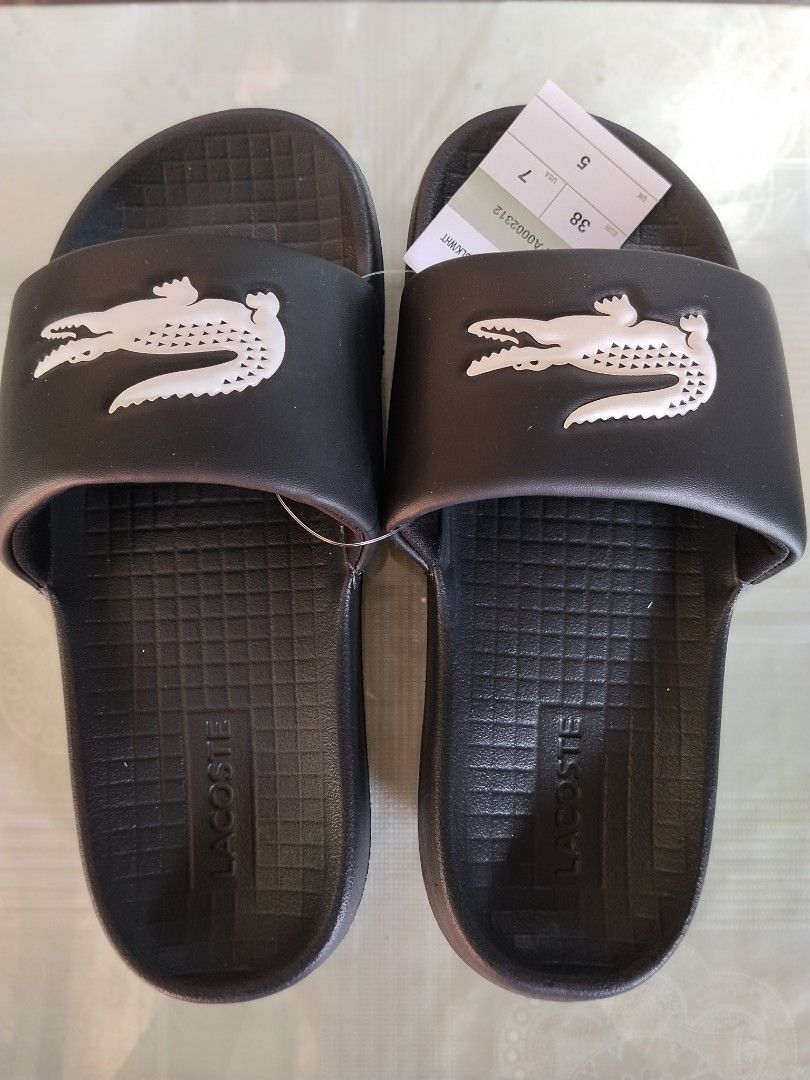 Lacoste Unisex Slide (Category: Slippers & Slides) located in General Mariano Alvarez. Submitted by iamnotjen (Listing ID 1470347386, Image 1). Description: Lacoste Serve Slide 1.0 Unisex Brand New and Authentic From Dubai plus sf Avail Size US 6,7,8,9,10,11.