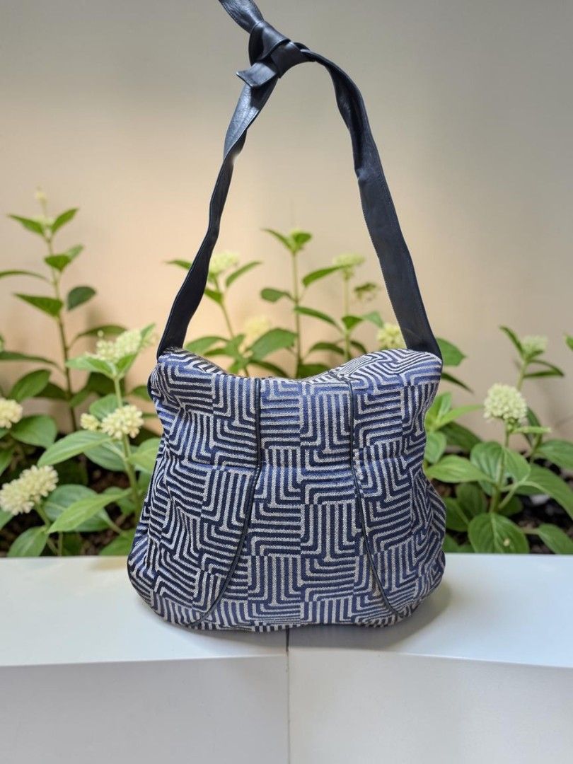 LANVIN PARIS GEOMETRIC CANVAS SHOULDER BAG (Category: Shoulder Bags) located in Las Pinas. Submitted by annachiaonair2037 (Listing ID 1470309427, Image 2). Description: LANVIN PARIS GEOMETRIC CANVAS SHOULDER BAG FROM JAPAN CANVAS WITH LEATHER TRIMMINGS FLAP OVER CLOSURE SELF TIE LEATHER STRAP TO ADJUST LENGTH NORMSL SIGN OF USAGE H 12" L 5" W 1.2" Disclaimer: I am not affiliated with, associated with, or authorized by any of the brands featured p