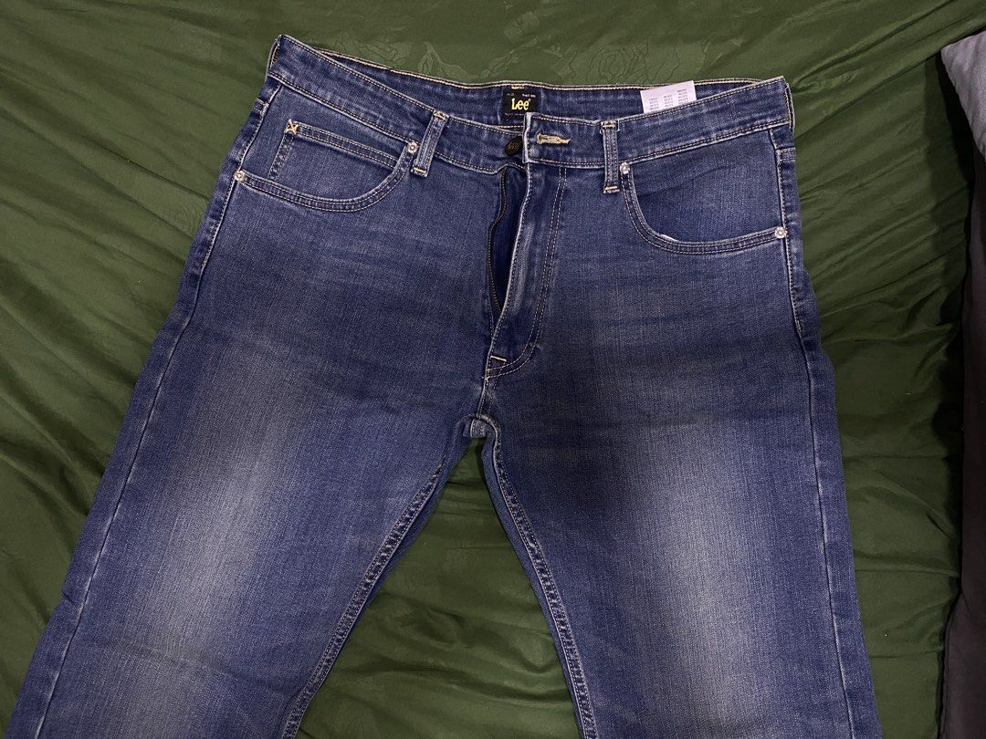Lee Blue Denim Jeans (Category: Jeans) located in Manila. Submitted by cyyruss (Listing ID 1470150874, Image 2). Description: - Brand: Lee - Color/Wash: Blue denim with natural fading on thighs - Style: Classic five-pocket design with contrast stitching - Closure: Button fly - Condition: Brand new with tags attached - Details: Inner waistband brand label.