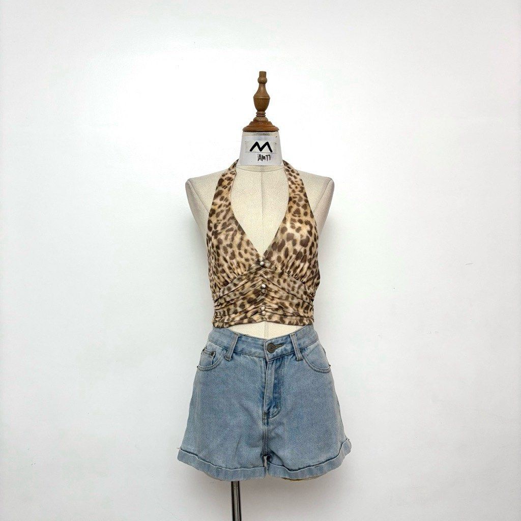Leopard Print Halter Top (Category: Sleeveless) located in Taguig. Submitted by cftbncs (Listing ID 1470320662, Image 1). Description: - Trendy leopard print halter top with a flattering plunging neckline - Cute ruched front panel accented with dainty pearl buttons - Cropped length that pairs effortlessly with high-waisted denim shorts - Lightweight, breathable fabric ideal for the PH weather - Condition: Brand new / Excellent.