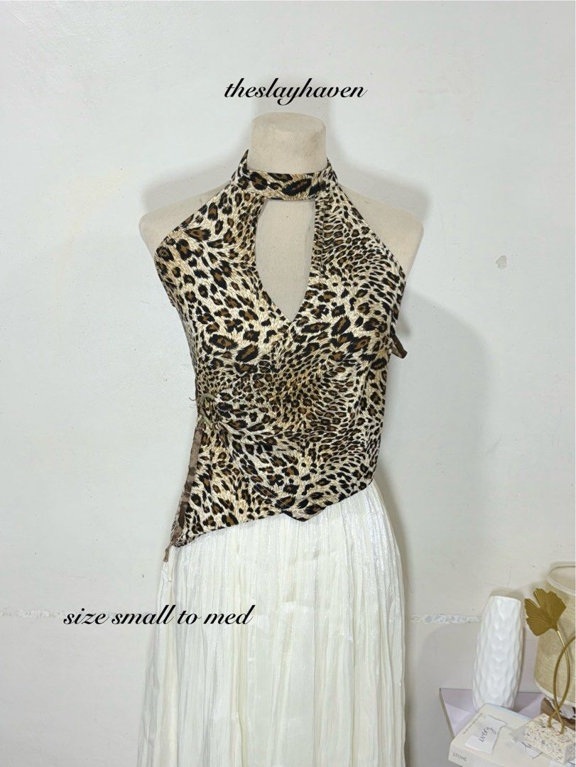 Leopard print halter top asymmetric cut out size S M (Category: Sleeveless) located in Manila. Submitted by biacakes (Listing ID 1470263922, Image 1). Description: - Design: Fierce leopard print halter top featuring a trendy asymmetric hem - Details: Chic keyhole cut out at the neckline with a stylish side ring accent - Fit: Comfortable stretch fabric designed to best fit sizes Small to Medium - Perfect For: Making a bold statement during nights 