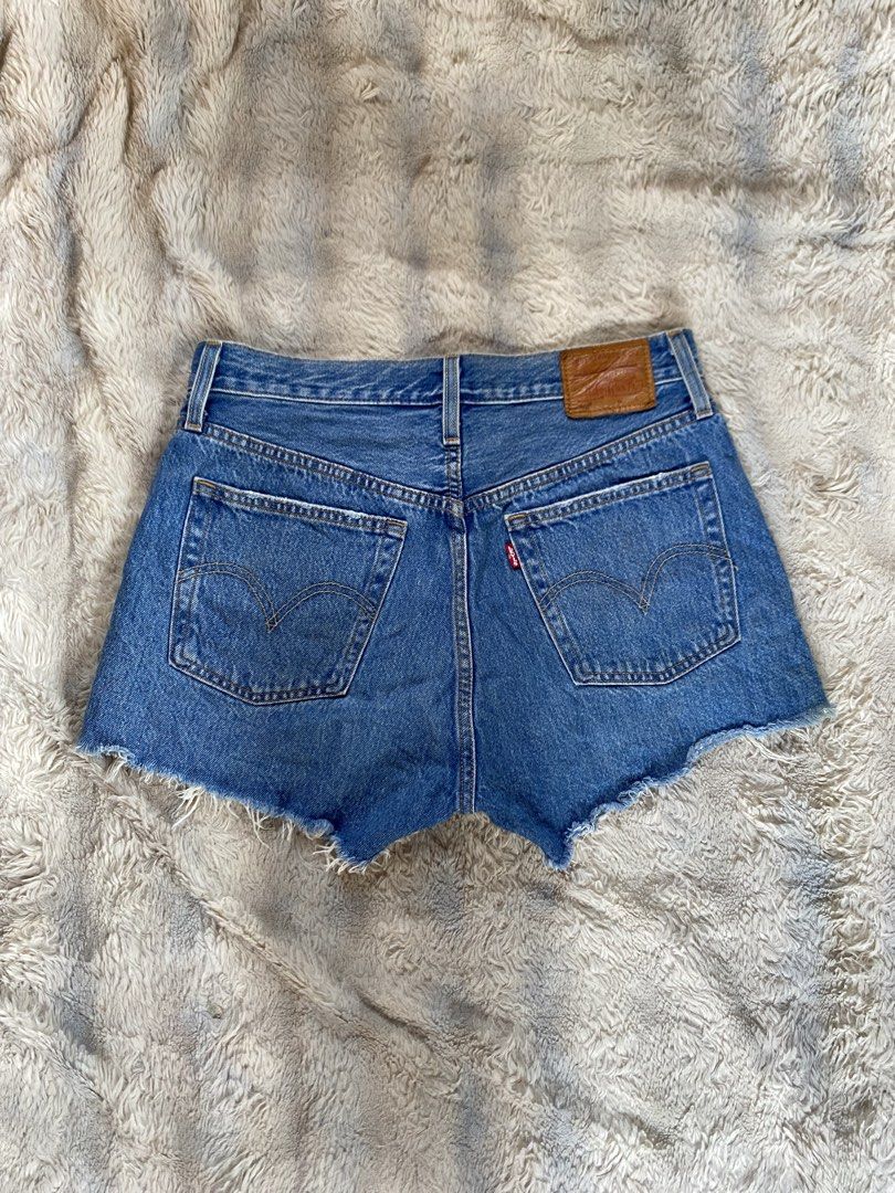 Levi's 501 Cutoff Denim Shorts Medium Wash (Category: Shorts) located in Andop. Submitted by safewater-895a (Listing ID 1470280491, Image 1). Description: - Brand: Levi's 501 - Style: High-waisted denim shorts with button fly - Wash: Medium blue - Details: Distressed front pocket, frayed raw hemline, classic back leather patch, and red tab - Condition: Great pre-loved staple for warm weather - Waistline: 30-31 - Lenght: 12 .