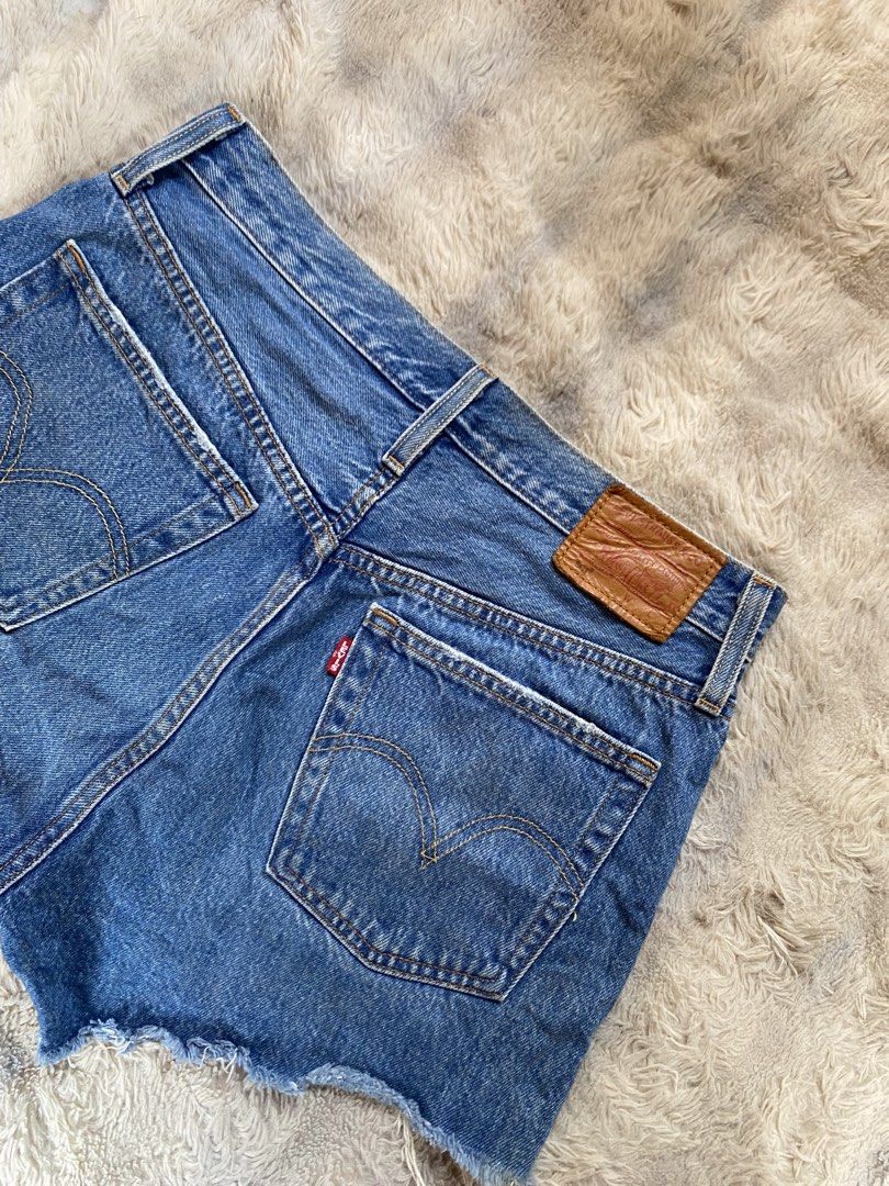 Levi's 501 Cutoff Denim Shorts Medium Wash (Category: Shorts) located in Andop. Submitted by safewater-895a (Listing ID 1470280491, Image 2). Description: - Brand: Levi's 501 - Style: High-waisted denim shorts with button fly - Wash: Medium blue - Details: Distressed front pocket, frayed raw hemline, classic back leather patch, and red tab - Condition: Great pre-loved staple for warm weather - Waistline: 30-31 - Lenght: 12 .