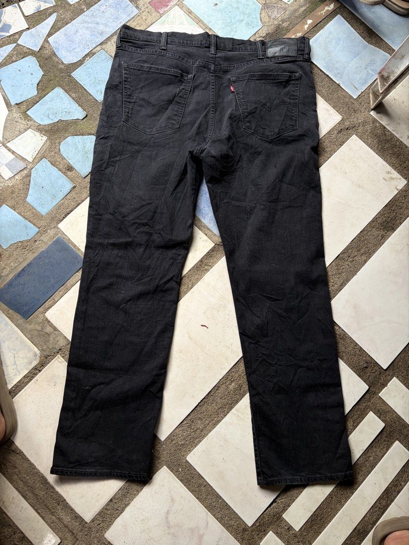 Levi's Black Denim Jeans (Category: Jeans) located in Manila. Submitted by nickol17 (Listing ID 1470154473, Image 2). Description: - Authentic black Levi's denim jeans in a solid black wash - Classic 5-pocket design with signature back pocket stitching - Genuine leather patch on the back waistband - Durable metal button fastening with stamped numbering - Unique heritage print detailing on the inner pocket lining.