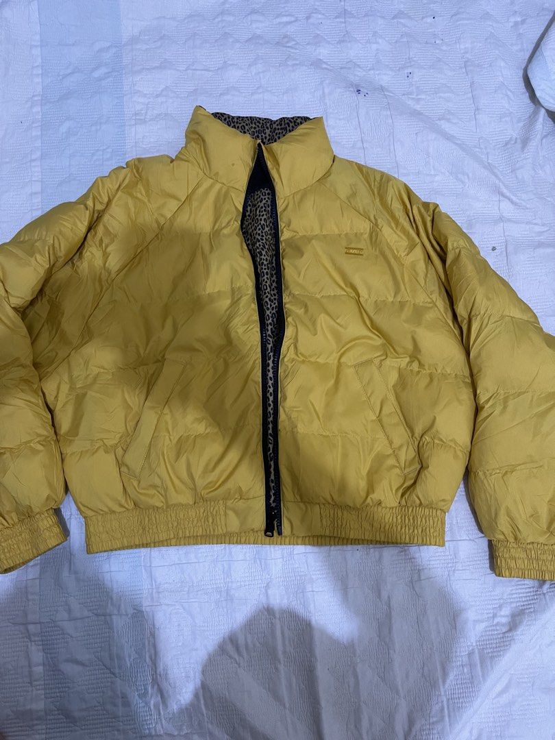 Levi's Reversible Puffer Jacket Yellow Leopard Print Size S (Category: Coats, Jackets and Outerwear) located in Caloocan City. Submitted by noblecat_c04f74 (Listing ID 1470156090, Image 1). Description: - Brand: Levi's - Style: Reversible puffer jacket - Size: Small - Side A: Solid yellow - Side B: Leopard print body with black sleeves - Features: Stand-up collar, front zip closure, elasticated cuffs and hem - Condition: Great find, highly versat
