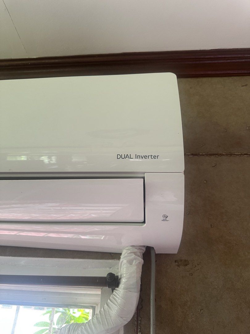LG DUAL Inverter Air Conditioner (Category: Air Conditioning and Heating) located in Amadeo. Submitted by maricarkim (Listing ID 1470161764, Image 2). Description: - LG Dual Inverter split type aircon in clean condition - 10-year compressor warranty label on front panel - Built-in Smart Diagnosis feature - Neat pipe insulation at the bottom right - Currently mounted above a window.
