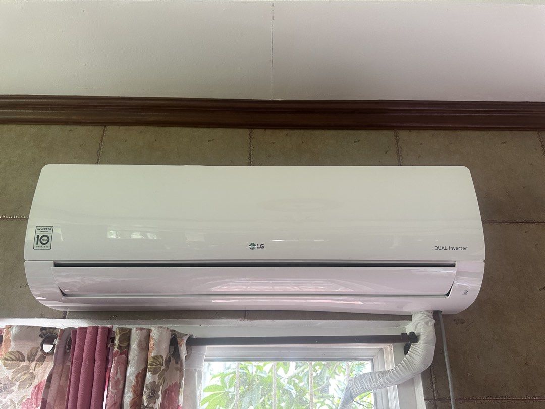 LG DUAL Inverter Air Conditioner (Category: Air Conditioning and Heating) located in Amadeo. Submitted by maricarkim (Listing ID 1470161764, Image 1). Description: - LG Dual Inverter split type aircon in clean condition - 10-year compressor warranty label on front panel - Built-in Smart Diagnosis feature - Neat pipe insulation at the bottom right - Currently mounted above a window.