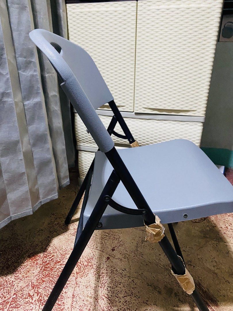 Lifetime grey folding chair (Category: Chairs) located in Makati City. Submitted by a_c_0_7 (Listing ID 1470272156, Image 3). Description: - Brand/Model: Lifetime folding chair in sleek grey - Sturdy Build: Durable plastic seat and backrest supported by a black painted metal frame - Portable: Convenient cutout handle near the top for effortless carrying - Space-Saving: Folds completely flat to easily slip behind doors or inside closets - Versatil