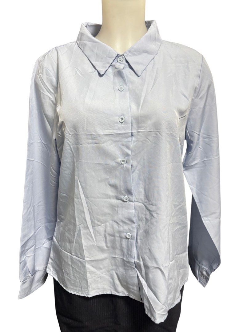 Light blue button-down long sleeve shirt blouse (Category: Longsleeves) located in Caloocan City. Submitted by shibowhii (Listing ID 1470225890, Image 1). Description: - Color: Light blue - Style: Long sleeve button-down with classic collar - Fit: Relaxed fit for all-day comfort - Details: Matching blue buttons and buttoned cuffs - Fabric: Smooth texture, great for work or casual outfits.