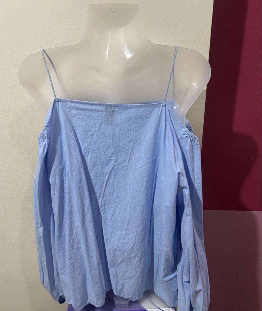 Light Blue Cold Shoulder Button Down Blouse (Category: Blouses) located in Marilao. Submitted by bamito (Listing ID 1470166880, Image 3). Description: - Color: Light blue - Design: Cold shoulder with spaghetti straps and square neckline - Details: Front button closure with white buttons - Fit: Relaxed fit through the body - Lightly Used.
