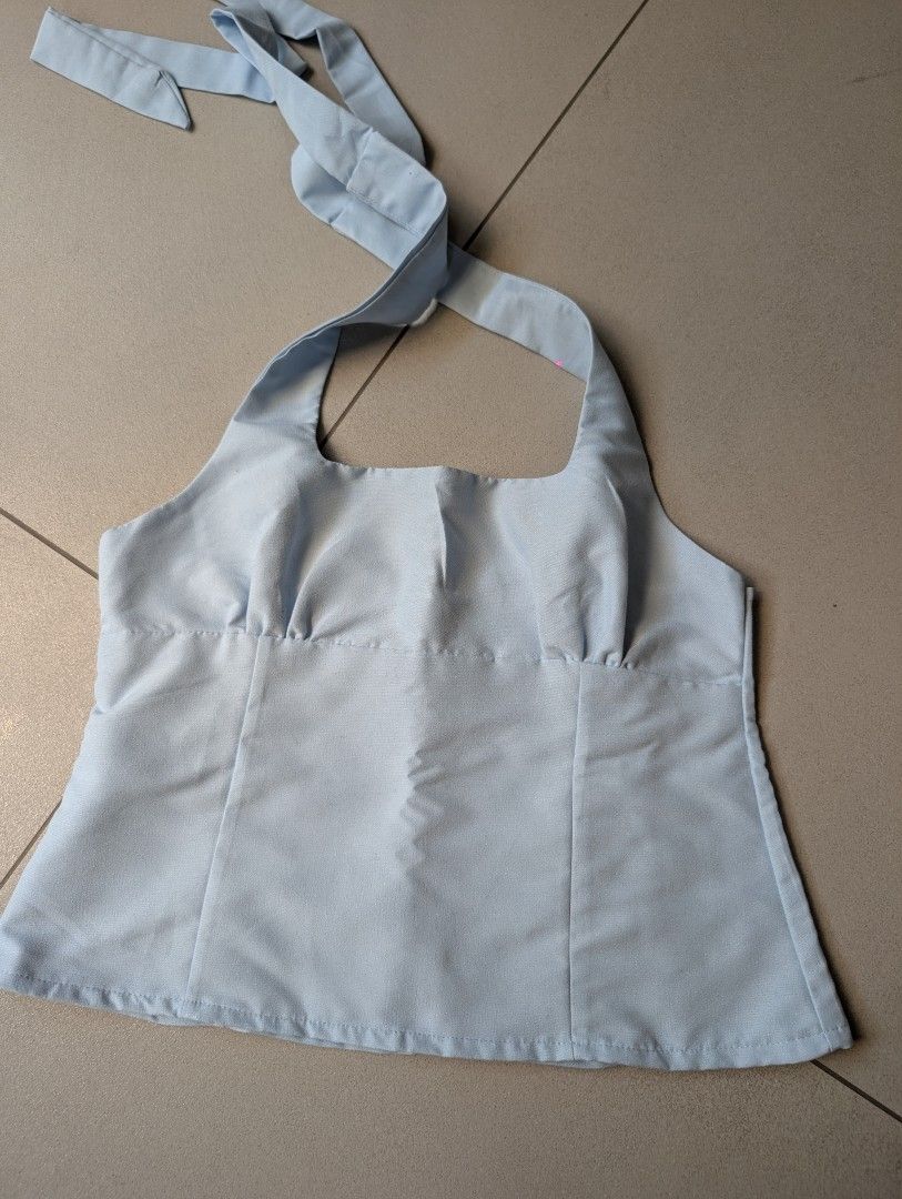 Light Blue Halter Neck Crop Top with Back Zip (Category: Sleeveless) located in Paranaque City. Submitted by clothingarchives (Listing ID 1470161649, Image 1). Description: - Color: Light blue pastel shade - Design: Halter neck with square neckline and adjustable button/tie straps - Fit: Fitted bodice with flattering vertical panel seams - Closure: Hidden back zipper - Style: Simple, chic summer essential - Condition: Excellent / Brand new.