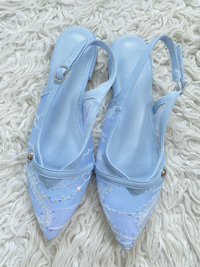 Light Blue Pointed Toe Slingback Flats with Floral Lace (Category: Flats & Sandals) located in Tabaco. Submitted by camila_p (Listing ID 1470154101, Image 3). Description: - Style: Light blue pointed toe slingback flats with a dainty and super pretty look - Details: Sheer mesh sides, white floral embroidery, and iridescent sequins - Heel & Fit: Low block heel and adjustable ankle strap with metal buckle - Materials: Synthetic leather trim.