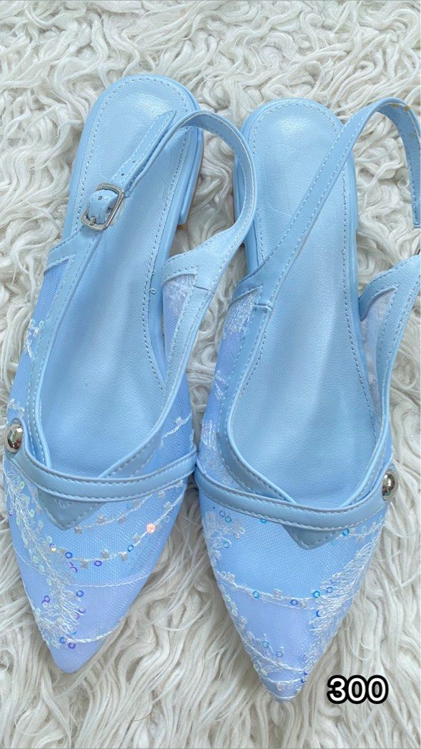 Light Blue Pointed Toe Slingback Flats with Floral Lace (Category: Flats & Sandals) located in Tabaco. Submitted by camila_p (Listing ID 1470154101, Image 1). Description: - Style: Light blue pointed toe slingback flats with a dainty and super pretty look - Details: Sheer mesh sides, white floral embroidery, and iridescent sequins - Heel & Fit: Low block heel and adjustable ankle strap with metal buckle - Materials: Synthetic leather trim.