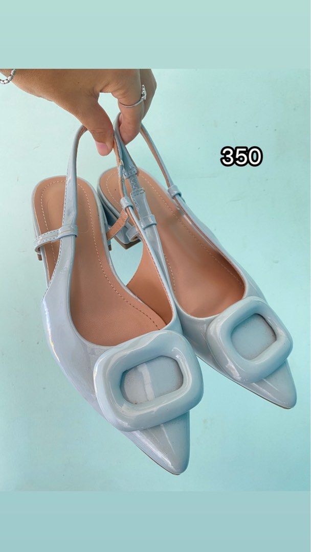 Light Blue Slingback Pointed Toe Heels With Buckle (Category: Heels) located in Tabaco. Submitted by camila_p (Listing ID 1470153753, Image 1). Description: - Color: Light blue with a glossy patent finish - Design: Pointed toes with trendy chunky square buckles - Heel: Comfortable block heel that is easy to walk in - Fit: Slingback strap with an adjustable buckle detail - Interior: Neutral nude lining - Condition: Clean, worn once for 30 mins.
