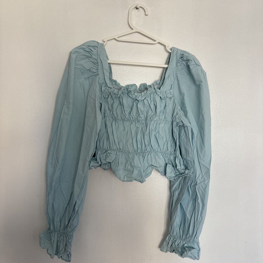 Light blue square neck crop top with puff sleeves (Category: Blouses) located in Pasig City. Submitted by _jinwifeu_ (Listing ID 1470222441, Image 2). Description: 📏 fits small to medium 📍 ortigas, pasig 💸 maribank,bdo, gcash, maya 🚚 same day delivery (lalamove, grab etc).