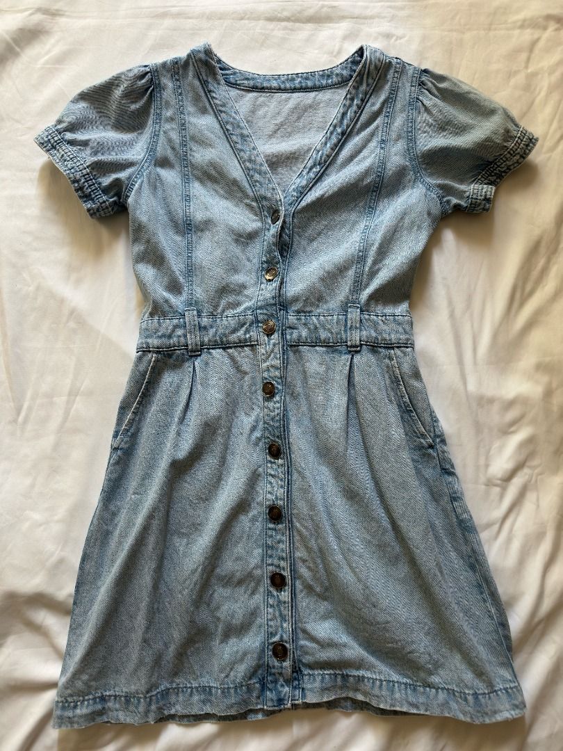 Light wash denim short sleeve button up mini dress (Category: Dresses) located in Cebu City. Submitted by _t.rix (Listing ID 1470182421, Image 1). Description: - Light wash denim mini dress with trendy faded acid wash effect - Features a flattering V-neckline and chic short puffed sleeves - Structured bodice seams and fitted waist with belt loops - Functional front button-down closure and convenient hip pockets - Cute skater-style flared skirt he