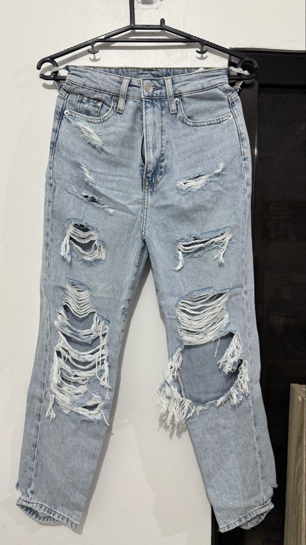 Light Wash Distressed Ripped Denim Jeans (Category: Jeans) located in Muntinlupa City. Submitted by maraaalpz (Listing ID 1470272535, Image 1). Description: - Style: High-rise fit with casual everyday appeal - Color/Wash: Light wash blue - Design: Heavy distressing and rips all over the front legs - Details: Front button closure, belt loops, and standard five-pocket design - Finish: Raw edge fraying around the knee cutouts - Pairing: Great to mat