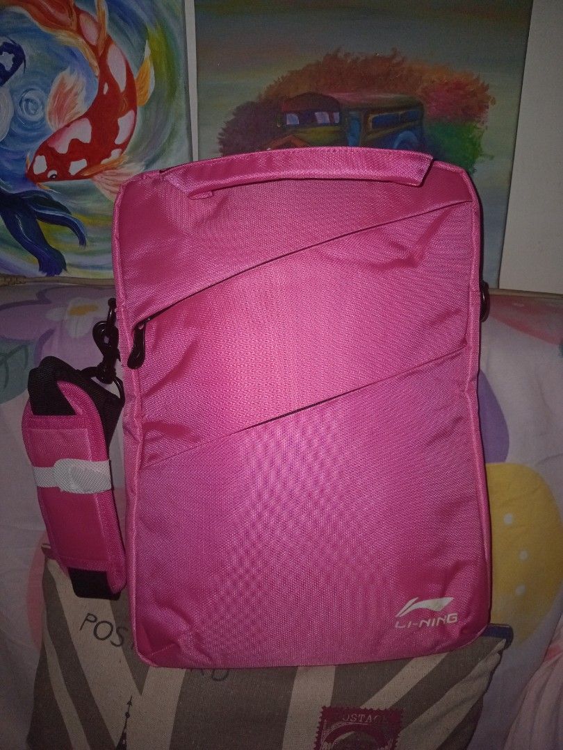Li-Ning Pink Laptop Bag with Shoulder Strap (Category: Laptop Bags & Sleeves) located in Rodriguez. Submitted by maycol (Listing ID 1470224578, Image 3). Description: - Brand: Li-Ning - Color: Bright pink - Condition: Clean exterior, shoulder strap still wrapped in plastic - Storage: Zippered main compartment and front zipped pocket - Portability: Sturdy top carrying handles and a matching adjustable shoulder strap - Ideal use: Practical for dail