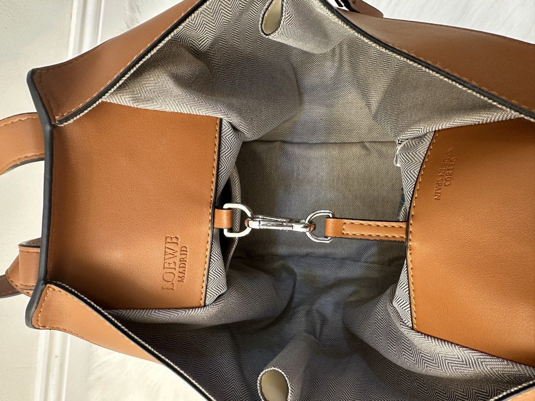 Loewe Hammock Bag Cream Tan (Category: Shoulder Bags) located in Manila. Submitted by audreyhepburn21 (Listing ID 1470315197, Image 2). Description: - Brand: Loewe - Style: Hammock Tote Bag - Color: Cream and Tan - Material: Premium Leather with Herringbone Canvas Interior - Features: Structured paneled design, dual top handles, detachable shoulder strap, and zip gussets - Authenticity: Includes embossed Loewe Madrid logo tag and serial number 01