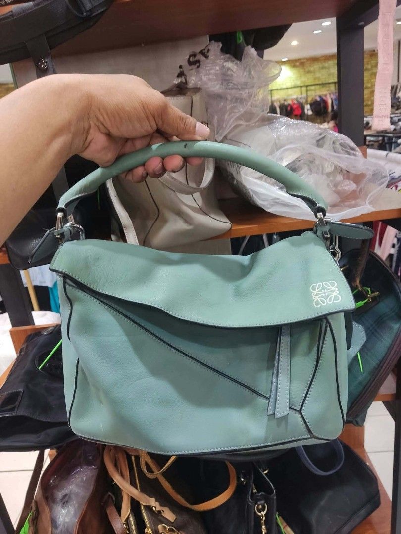 Loewe Hammock Light Blue Leather Shoulder Bag (Category: Luxury Bags & Wallets) located in Bay. Submitted by silverhorse-59c851 (Listing ID 1470269207, Image 1). Description: Light blue leather Loewe Hammock handbag. Structured shape with folded sides and top handles. Silver-tone hardware and top zip closure. Interior lined in beige chevron fabric with slip pockets. Debossed Loewe logo on the front corner. Includes interior leather brand tag and 