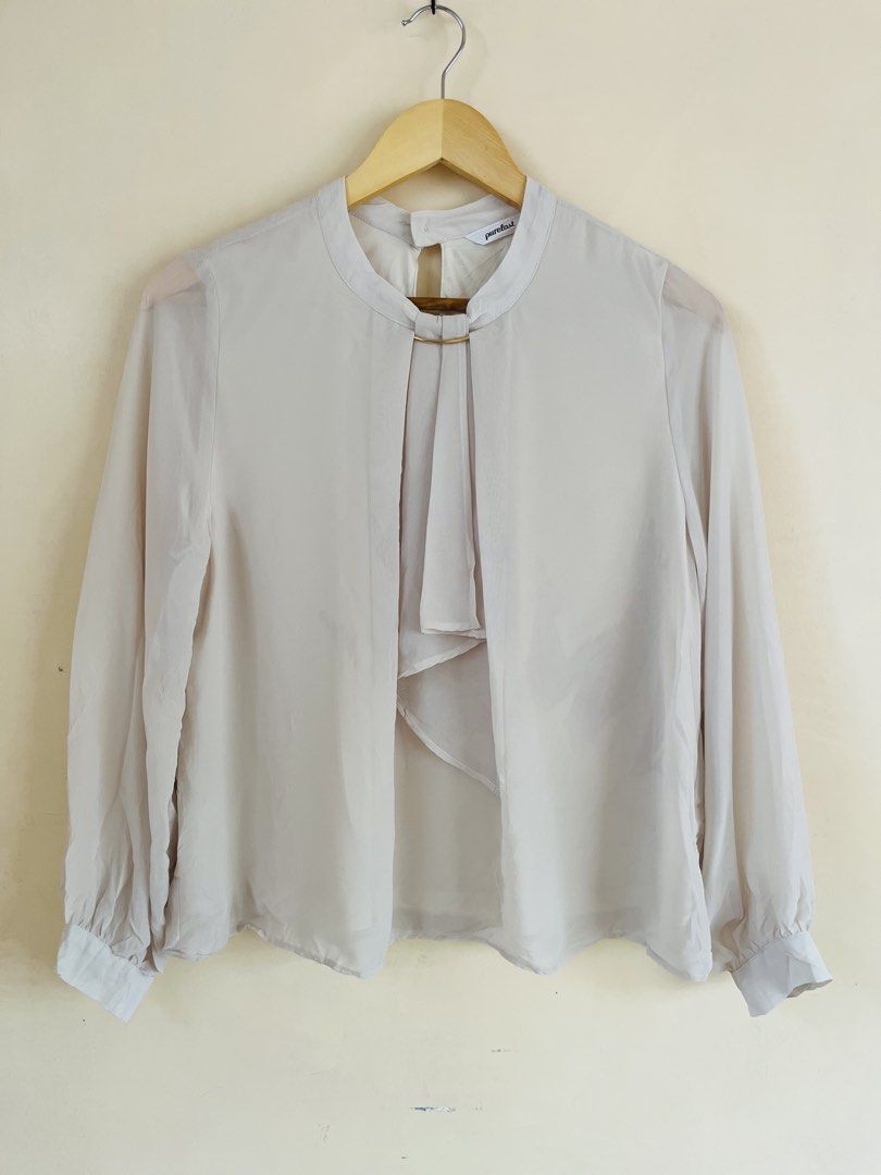 Long Sleeve Blouse with Gold Ring Detail (Category: Longsleeves) located in Binan City. Submitted by hannahbanana928 (Listing ID 1470206403, Image 2). Description: - Brand: Purelast - Color: Off White - Material: Lightweight chiffon-like fabric (semi-sheer sleeves) - Design: Round neckline with subtle gold ring accent and stylish front drape panel - Closure: Button closure at the back neck - Styling: Perfect for office wear or casual outings, eas
