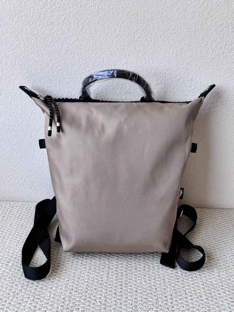 Longchamp Backpack (Category: Backpacks) located in Singapore. Submitted by sg_vela_professional_seller (Listing ID 1470204313, Image 1). Description: - Brand: Longchamp - Color: Neutral beige with black accents and hardware - Material: Lightweight, durable nylon fabric with sturdy straps - Features: Signature Longchamp branding, secure zippered outer pocket, and adjustable shoulder straps - Condition: Brand new and unused - Ideal for: Everyday c