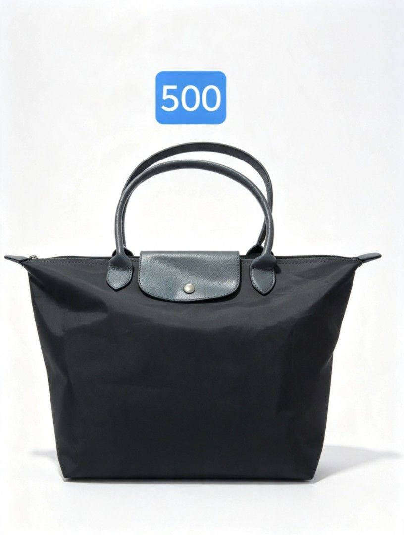 grey nylon tote bag (Category: Tote Bags) located in Angeles City. Submitted by anneps (Listing ID 1470214078, Image 1). Description: - Color: Grey - Material: Durable nylon with leather front flap and snap button fastener - Closure: Secure top zip closure - Interior: Spacious with a handy slip pocket and clean grey lining - Structure: Flat base keeps the bag standing upright - Handles: Comfortable top handles for easy carrying.